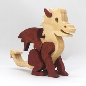 Hand-crafted baby dragon mythical fantasy animal figurine made from contrasting high-quality hardwoods and finished with non-toxic oils and waxes. Perfect for any dragon enthusiast.