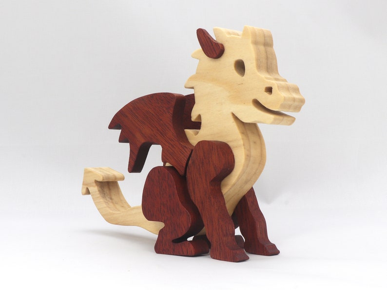 Hand-crafted baby dragon mythical fantasy animal figurine made from contrasting high-quality hardwoods and finished with non-toxic oils and waxes. Perfect for any dragon enthusiast.