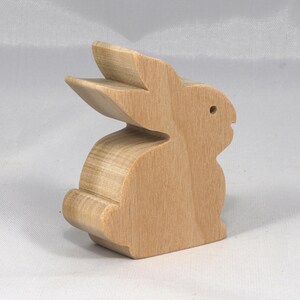 This is an unfinished wooden Rabbit cutout from solid wood using traditional woodworking techniques. Sanded smooth and ready to paint, stain, or customize. Freestanding design for small hands, toddlers, young children, crafters, collectors, and display. I take custom orders for any animal, quantity, and mix — including large ornament orders. Mix and match, request a different size, or send a drawing or pattern. Handmade by Odin's Toy Factory in Tallahassee, Florida, USA.