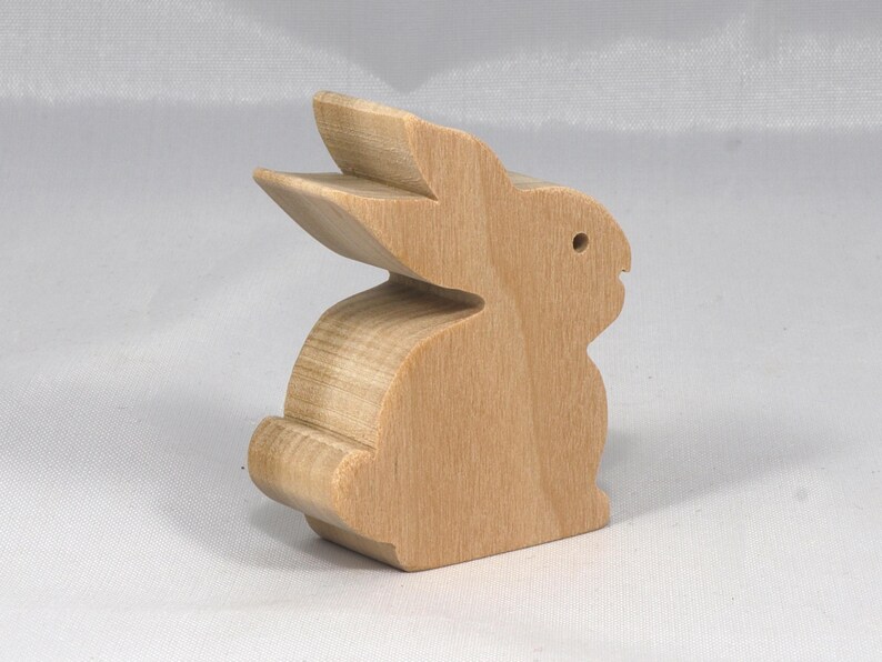 This is an unfinished wooden Rabbit cutout from solid wood using traditional woodworking techniques. Sanded smooth and ready to paint, stain, or customize. Freestanding design for small hands, toddlers, young children, crafters, collectors, and display. I take custom orders for any animal, quantity, and mix — including large ornament orders. Mix and match, request a different size, or send a drawing or pattern. Handmade by Odin's Toy Factory in Tallahassee, Florida, USA.