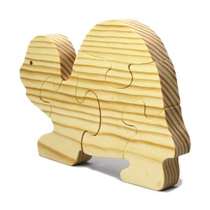 Handmade wooden turtle puzzle with 5 simple interlocking pieces. Freestanding 5-piece wooden puzzle. Approximate dimensions: 5 inches high by 7.25 inches long by 0.75 inches thick. Finished with mineral oil and beeswax blend. Handcrafted in Tallahassee, Florida, USA, using natural wood. Unique wood grain color and knot variations. Odin’s Toy Factory.