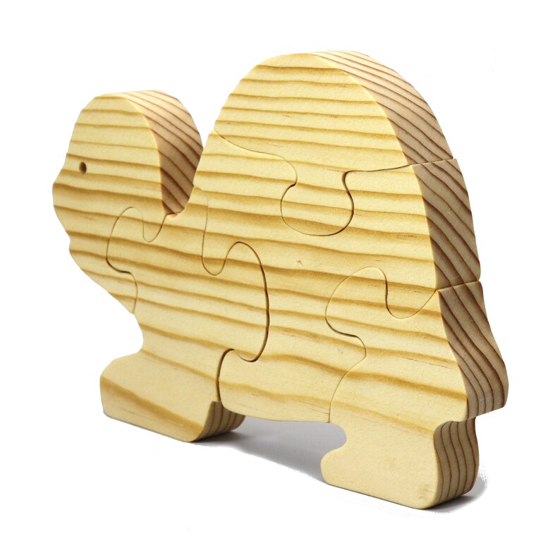 Handmade wooden turtle puzzle with 5 simple interlocking pieces. Freestanding 5-piece wooden puzzle. Approximate dimensions: 5 inches high by 7.25 inches long by 0.75 inches thick. Finished with mineral oil and beeswax blend. Handcrafted in Tallahassee, Florida, USA, using natural wood. Unique wood grain color and knot variations. Odin’s Toy Factory.