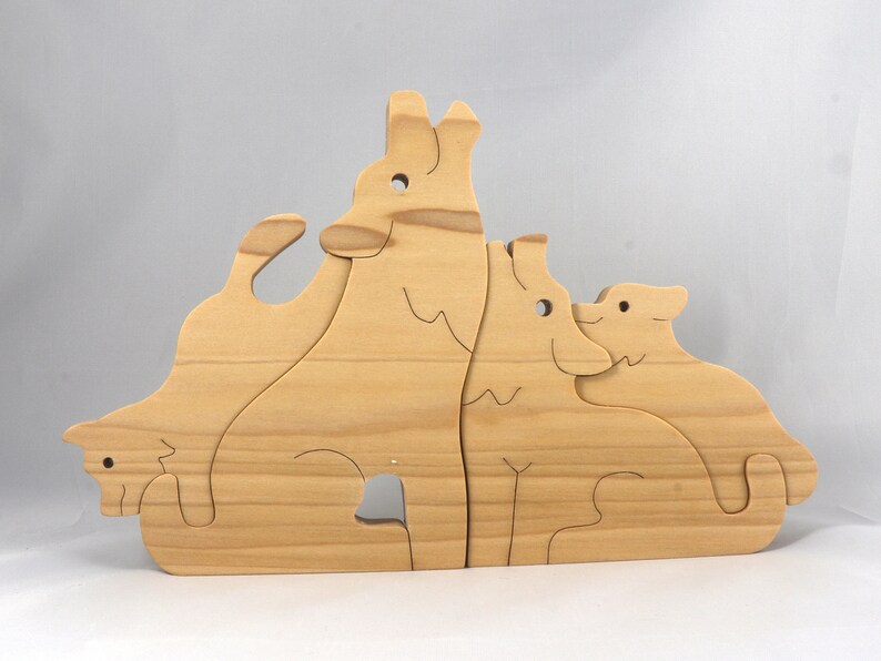 Wooden Wolf Family Stacking Puzzle is handmade from hardwood and finished with mineral oil, beeswax, and carnauba wax. Freestanding interlocking wolf family puzzle pieces shown assembled. Approximate size 10.5 inches long by 6.7 inches high by 3/4 inch thick. Handmade in Tallahassee, Florida, USA.