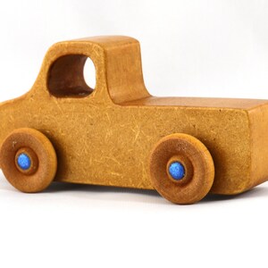 This handmade toy pickup truck from My Play Pal Collection is finished with amber shellac and metallic sapphire blue acrylic paint. It is just one of many unique wooden vehicles available.