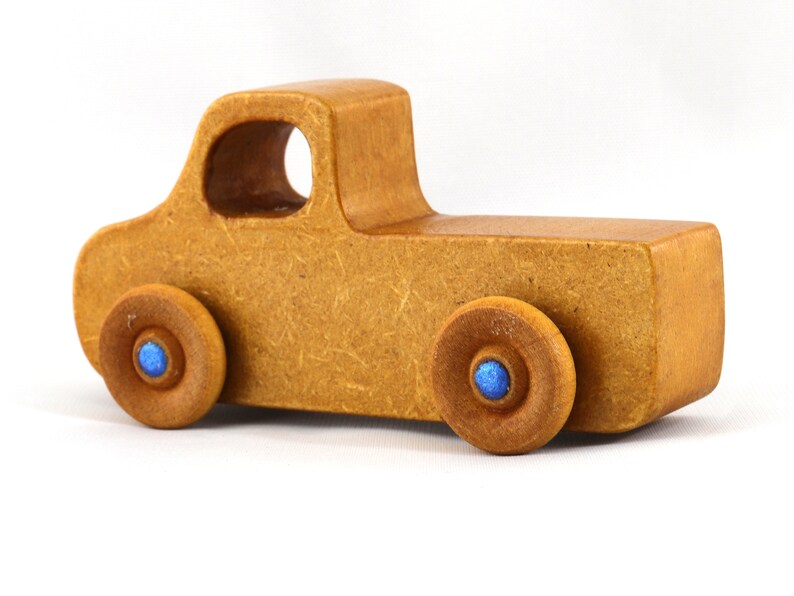 This handmade toy pickup truck from My Play Pal Collection is finished with amber shellac and metallic sapphire blue acrylic paint. It is just one of many unique wooden vehicles available.