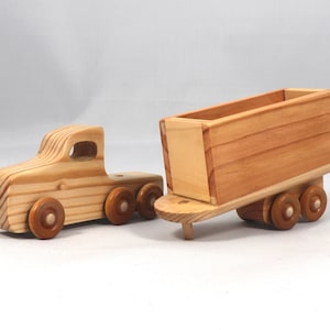Handmade wooden toy tractor trailer semi truck finished with clear shellac. Crafted from natural wood using traditional woodworking tools. Approximate size 7 inches long. Made in Tallahassee, Florida, USA from Odin's Toy Factory Play Pal Collection.