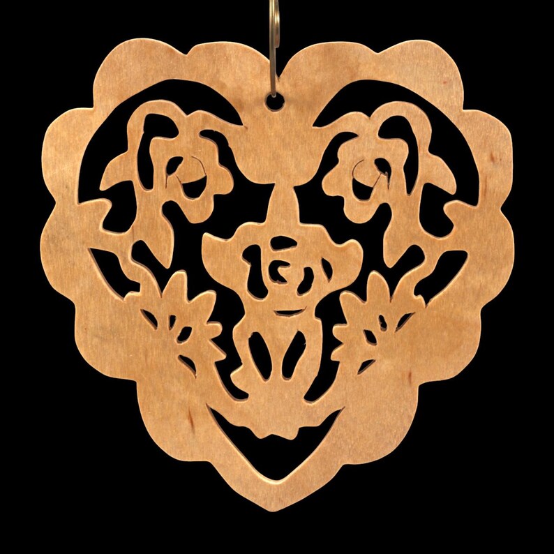 A handmade wooden Victorian-style fretwork floral heart Christmas tree ornament, featuring intricate cutout floral patterns in a heart shape, with a warm natural wood finish.