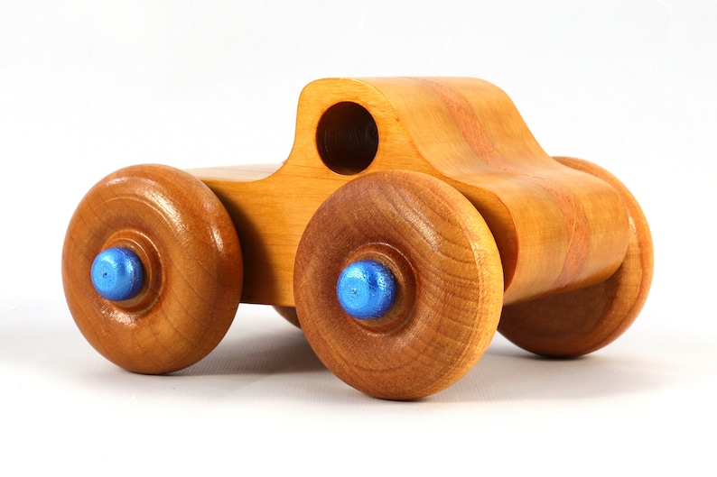 Wood Toy Monster Truck Handmade Form Hardwood and Finished With Amber Shellac With Metallic Saphire Blue Trim.