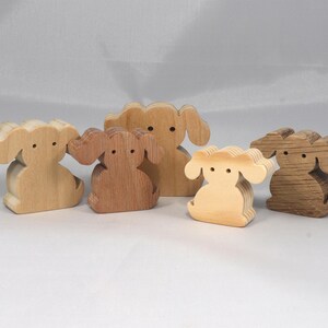 This is an unfinished wooden Puppy Dog cutout from solid wood using traditional woodworking techniques. Sanded smooth and ready to paint, stain, or customize. Freestanding design for small hands, toddlers, young children, crafters, collectors, and display. I take custom orders for any animal, quantity, and mix — including large ornament orders. Mix and match, request a different size, or send a drawing or pattern. Handmade by Odin's Toy Factory in Tallahassee, Florida, USA.