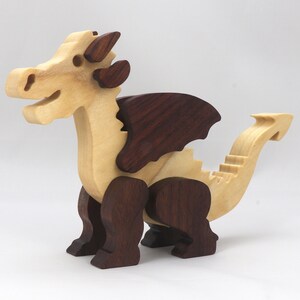 Wood Dragon Fantasy Animal Figurine is Handmade and finished with a renewable blend of mineral oil and waxes Applied hot for durabiliity and to enhance the beauty of the wood. There are ten dragons in this collection. A  link is in the description.