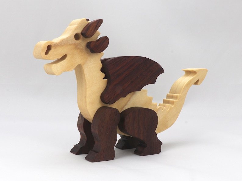 Wood Dragon Fantasy Animal Figurine is Handmade and finished with a renewable blend of mineral oil and waxes Applied hot for durabiliity and to enhance the beauty of the wood. There are ten dragons in this collection. A  link is in the description.