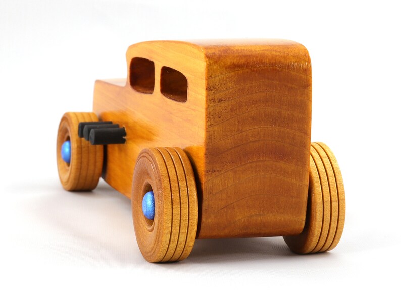 Handcrafted wooden hot rod toy car modeled after a classic '32 sedan. Finished with amber shellac and adorned with metallic sapphire blue and black trim. This unique piece is part of my Hot Rod Collection.