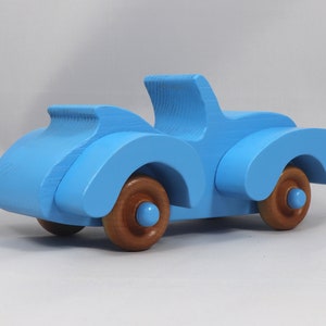 Handmade painted wooden toy car, baby blue convertible with fat fendered roadster design. Non-marring wheels finished with amber shellac.