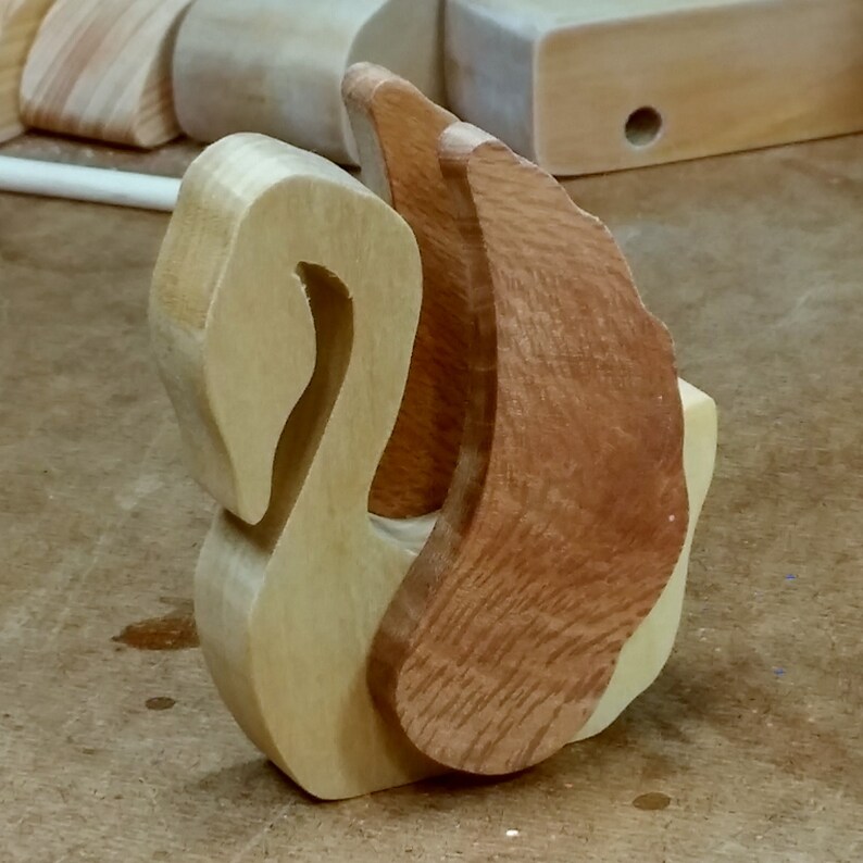 Handmade wooden swan figurine crafted from contrasting reclaimed hardwoods, sanded and ready to finish, and made in the USA.