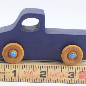 Handmade wooden toy pickup truck handmade and painted navy blue with amber shellac wheels and metallic sapphire blue trim. It's a little blue truck from my Play Pal Collection.