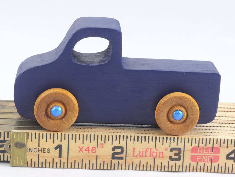 Handmade wooden toy pickup truck handmade and painted navy blue with amber shellac wheels and metallic sapphire blue trim. It's a little blue truck from my Play Pal Collection.