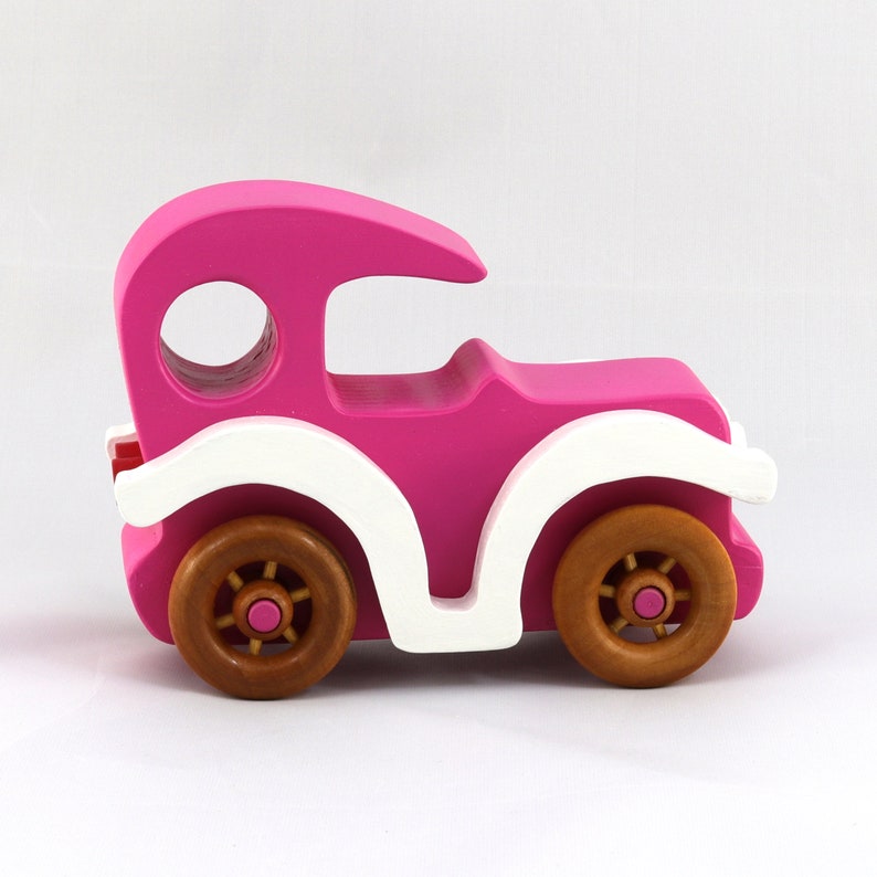 Handmade wooden toy car model-t sedan finished with hot pink and white acrylic paint with nonmaring amber shellac coated spoked wheels from my Bad Bob'S Custom Motors Collection.