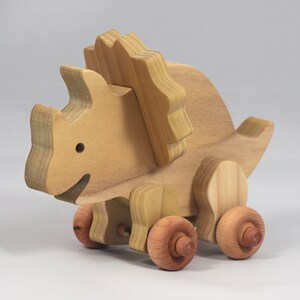 Handmade wooden push toy Triceratops dinosaur made from select grade hardwoods and finished with a non-toxic coating.