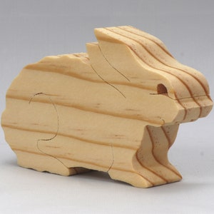 This is an unfinished wooden Rabbit cutout from solid wood using traditional woodworking techniques. Sanded smooth and ready to paint, stain, or customize. Freestanding design for small hands, toddlers, young children, crafters, collectors, and display. I take custom orders for any animal, quantity, and mix — including large ornament orders. Mix and match, request a different size, or send a drawing or pattern. Handmade by Odin's Toy Factory in Tallahassee, Florida, USA.