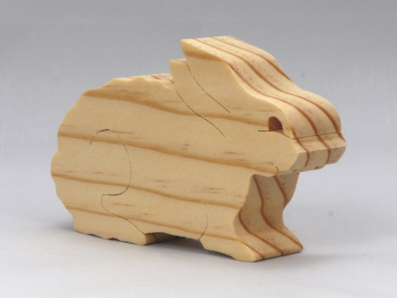 This is an unfinished wooden Rabbit cutout from solid wood using traditional woodworking techniques. Sanded smooth and ready to paint, stain, or customize. Freestanding design for small hands, toddlers, young children, crafters, collectors, and display. I take custom orders for any animal, quantity, and mix — including large ornament orders. Mix and match, request a different size, or send a drawing or pattern. Handmade by Odin's Toy Factory in Tallahassee, Florida, USA.