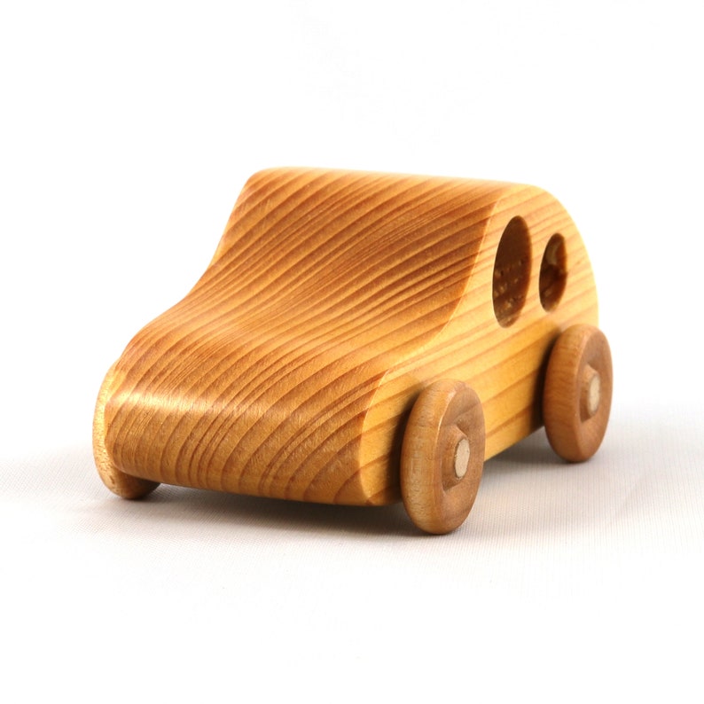 A handmade wooden toy car from the My Play Pal collection finished with durable satin polyurethane and amber shellac. It is made to order.