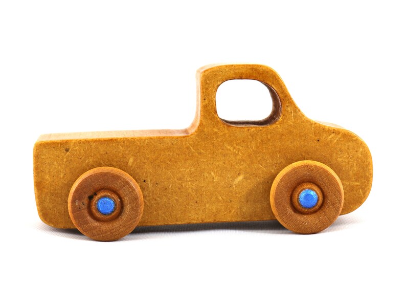This handmade toy pickup truck from My Play Pal Collection is finished with amber shellac and metallic sapphire blue acrylic paint. It is just one of many unique wooden vehicles available.