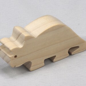 This is an unfinished wooden Wooden Toy Dinosaur Triceratops cutout from solid wood using traditional woodworking techniques. Sanded smooth and ready to paint, stain, or customize. Freestanding design for small hands, toddlers, young children, crafters, collectors, and display. I take custom orders for any animal, quantity, and mix — including large ornament orders. Mix and match, request a different size, or send a drawing or pattern. Handmade by Odin's Toy Factory in Tallahassee, Florida, USA.