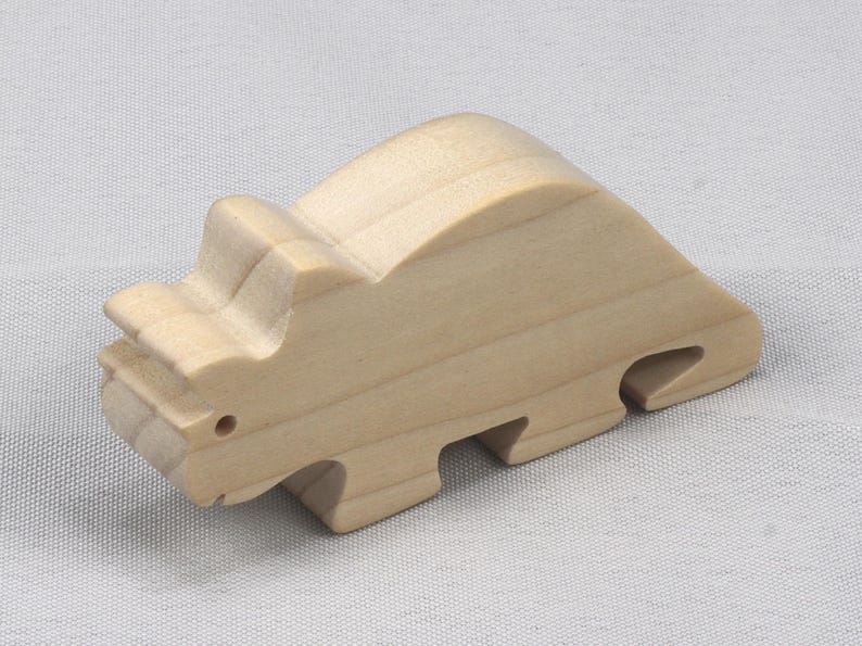 This is an unfinished wooden Wooden Toy Dinosaur Triceratops cutout from solid wood using traditional woodworking techniques. Sanded smooth and ready to paint, stain, or customize. Freestanding design for small hands, toddlers, young children, crafters, collectors, and display. I take custom orders for any animal, quantity, and mix — including large ornament orders. Mix and match, request a different size, or send a drawing or pattern. Handmade by Odin's Toy Factory in Tallahassee, Florida, USA.