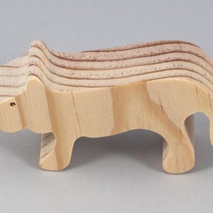 This is an unfinished wooden lioness cutout from solid wood using traditional woodworking techniques. Sanded smooth and ready to paint, stain, or customize. Freestanding design for small hands, toddlers, young children, crafters, collectors, and display. I take custom orders for any animal, quantity, and mix — including large ornament orders. Mix and match, request a different size, or send a drawing or pattern. Handmade by Odin's Toy Factory in Tallahassee, Florida, USA.