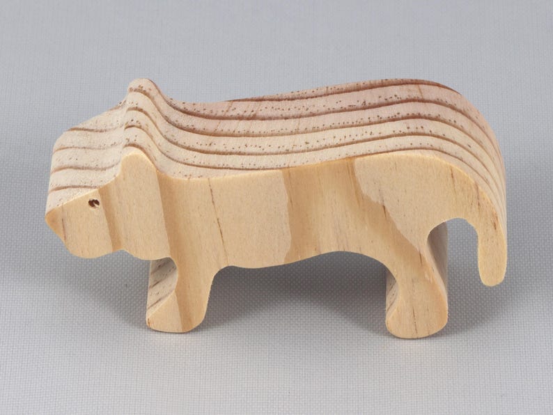 This is an unfinished wooden lioness cutout from solid wood using traditional woodworking techniques. Sanded smooth and ready to paint, stain, or customize. Freestanding design for small hands, toddlers, young children, crafters, collectors, and display. I take custom orders for any animal, quantity, and mix — including large ornament orders. Mix and match, request a different size, or send a drawing or pattern. Handmade by Odin's Toy Factory in Tallahassee, Florida, USA.