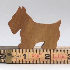 Handmade wooden Scottie dog toy cutout finished with mineral oil and beeswax blend. Freestanding stackable design from my Itty Bitty Animal Collection. Handcrafted in Tallahassee, Florida, USA from quality hardwood. Approximate size: length 2-1/2 inches, height 2 inches, width 3/4 inch. Each piece is unique with natural wood grain variations.
