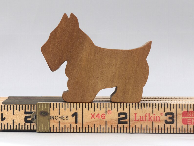 Handmade wooden Scottie dog toy cutout finished with mineral oil and beeswax blend. Freestanding stackable design from my Itty Bitty Animal Collection. Handcrafted in Tallahassee, Florida, USA from quality hardwood. Approximate size: length 2-1/2 inches, height 2 inches, width 3/4 inch. Each piece is unique with natural wood grain variations.