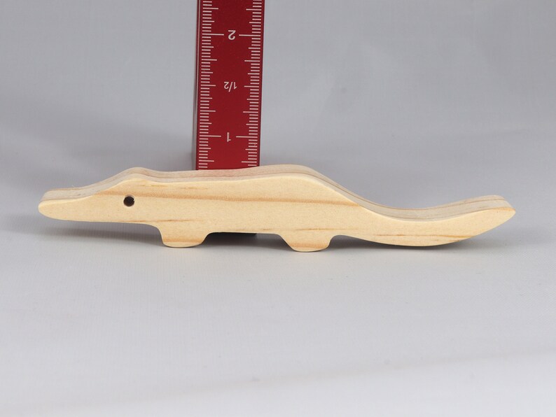 Handmade toy alligator cutout from the Itty Bitty Animal Collection. Crafted with traditional woodworking tools, this unfinished wood alligator is freestanding, smooth-sanded, and ready to paint. Perfect for stacking and imaginative play.