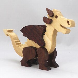 Wood Dragon Fantasy Animal Figurine is Handmade and finished with a renewable blend of mineral oil and waxes Applied hot for durabiliity and to enhance the beauty of the wood. There are ten dragons in this collection. A  link is in the description.