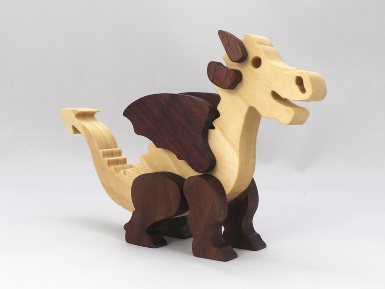 Wood Dragon Fantasy Animal Figurine is Handmade and finished with a renewable blend of mineral oil and waxes Applied hot for durabiliity and to enhance the beauty of the wood. There are ten dragons in this collection. A  link is in the description.