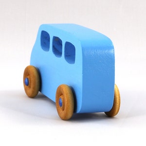 A Handmade wood toy mini van hand-painted baby blue with metallic sapphire blue trim and wheels finished with nonmarring amber shellac from my Play Pall Collection.