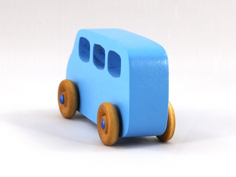 A Handmade wood toy mini van hand-painted baby blue with metallic sapphire blue trim and wheels finished with nonmarring amber shellac from my Play Pall Collection.