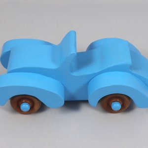 Handmade painted wooden toy car, baby blue convertible with fat fendered roadster design. Non-marring wheels finished with amber shellac.
