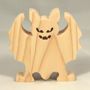 Handmade unpainted wooden Halloween bat cutout, freestanding light-colored solid wood figure with spooky carved face and outstretched wings, ready to paint, from my Snazzy Spooks collection.