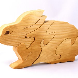 A wooden four piece puzzle in the shape of a rabbit. Perfect toddlers first puzzle.