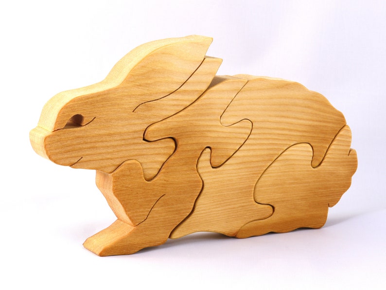 A wooden four piece puzzle in the shape of a rabbit. Perfect toddlers first puzzle.