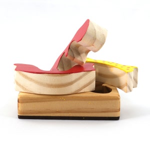 A wooden three-piece butterfly tray puzzle, handmade and finished. The butterfly is painted bright red and yellow with orange spots. The wooden tray is finished with clear shellac. It is one of four puzzles in my Puzzle Pals Collection.