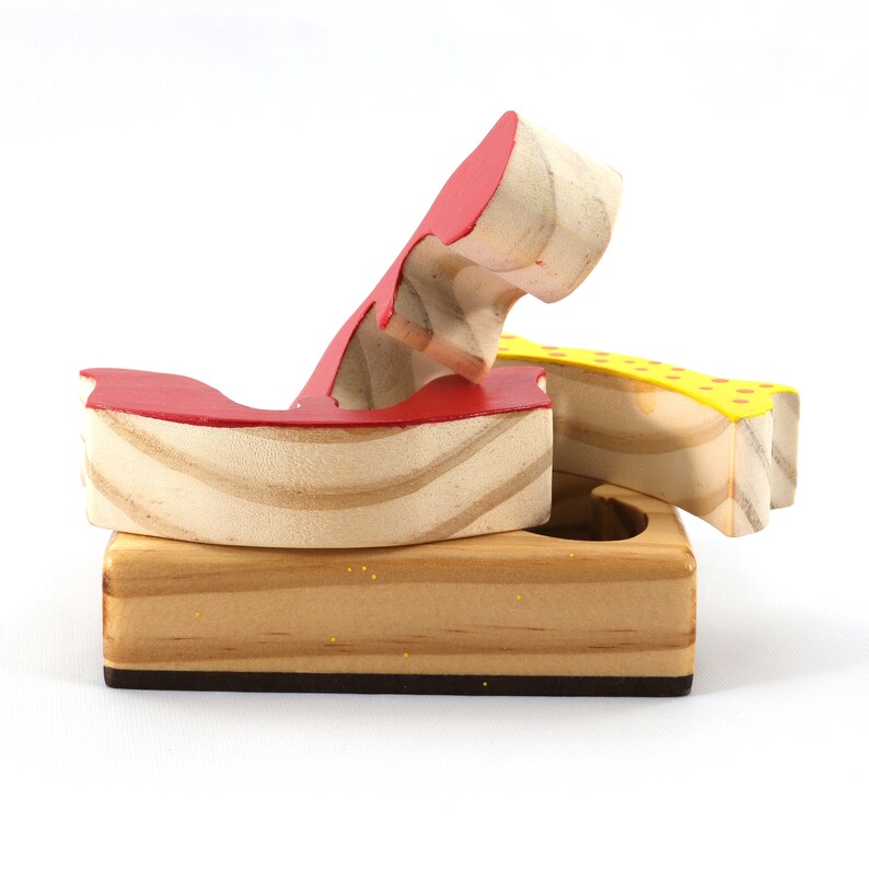 A wooden three-piece butterfly tray puzzle, handmade and finished. The butterfly is painted bright red and yellow with orange spots. The wooden tray is finished with clear shellac. It is one of four puzzles in my Puzzle Pals Collection.