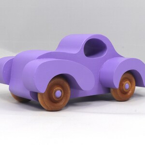 A Handmade Wood Toy Car Fat Fendered Coupe Hand Painted With Amethyst Acrylic Paint And Amber Shellac