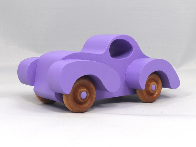 A Handmade Wood Toy Car Fat Fendered Coupe Hand Painted With Amethyst Acrylic Paint And Amber Shellac