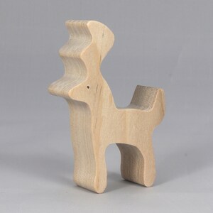 Handmade unfinished wooden deer toy figurine, part of the Itty Bitty Animal Collection, shown in natural light wood with visible grain, standing on a white background.