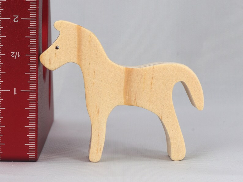 Handmade wooden toy horse cutout, perfect for children's playtime collection. Freestanding and stackable, ready to paint or customize. Endless possibilities for imaginative play, from farm scenes to towering animal creations.