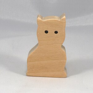 A handmade freestanding wooden toy cat cutout 1/2-3/4 inches thick is made from various kinds of wood sanded smooth and ready to paint. It is excellent for kids' crafts, pretend, or stacking toys. Other sizes are available with a custom order.