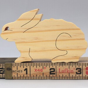 This is an unfinished wooden Rabbit cutout from solid wood using traditional woodworking techniques. Sanded smooth and ready to paint, stain, or customize. Freestanding design for small hands, toddlers, young children, crafters, collectors, and display. I take custom orders for any animal, quantity, and mix — including large ornament orders. Mix and match, request a different size, or send a drawing or pattern. Handmade by Odin's Toy Factory in Tallahassee, Florida, USA.