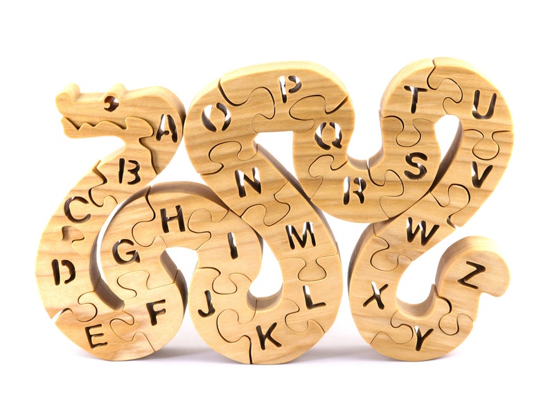 Hand-cut Alphabet Snake Puzzle made from premium hardwood, finished with mineral oil and beeswax for durability. Each of the 26 pieces represents a letter, promoting alphabet learning and essential skills development in kids through play.